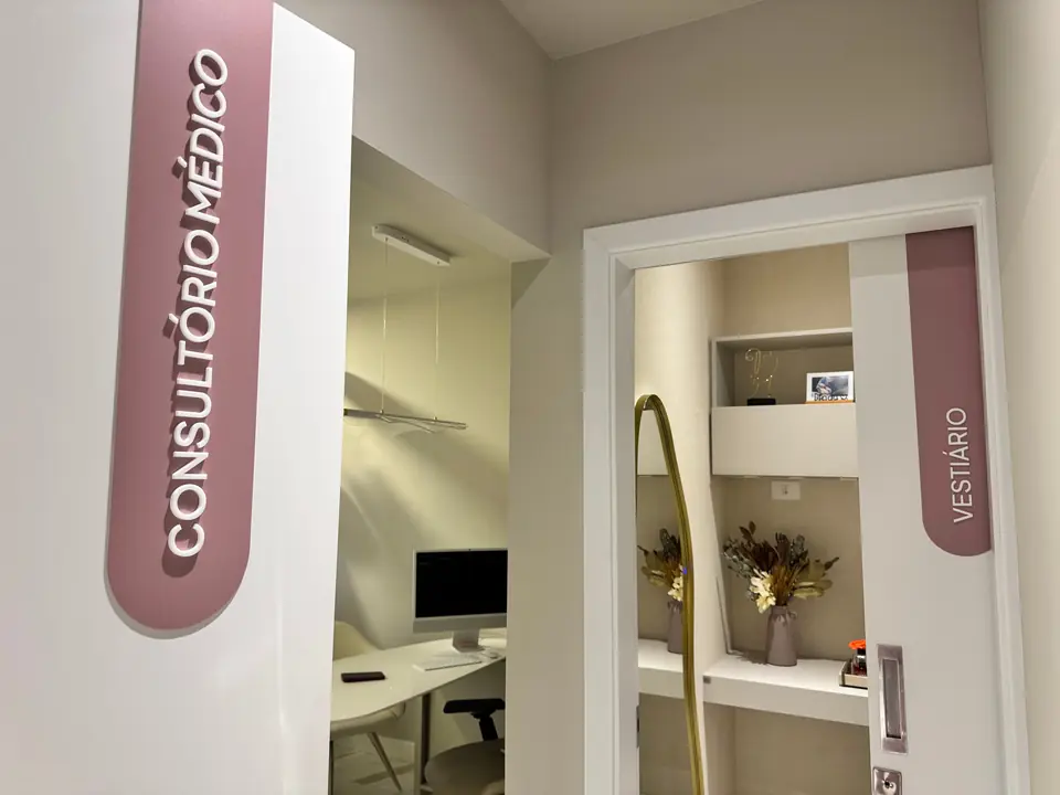 Portas do consultório médico e do vestiário, com placas rosadas